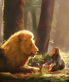 a woman sitting on the ground next to a lion in a forest with trees and grass