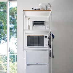 a white microwave oven sitting on top of a shelf