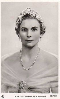 an old black and white photo of a woman wearing a tiara