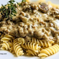 pasta with mushrooms and gravy on a white plate