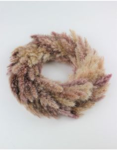 a close up of a fur scarf on a white surface with no people around it