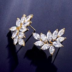 A delightfully unique pair of bridal earrings with an incredible sparkle! Adorned with flawlessly faceted cubic zirconia that capture the light in a dazzling array of sparkles, the earrings are rhodium plated for a bright finish which enhances the intricate detailing and conveys a modern take on old elegance. The earrings are 1" (approx. 2.5cm) in length and come with sturdy backs. Available in Silver, Rose Gold and Yellow Gold finishes. To make your choice select your preferred finish from the Rose Gold Cubic Zirconia Flower Earrings For Party, Sparkling Cubic Zirconia Flower Earrings For Anniversary, Anniversary Flower Earrings With Sparkling Cubic Zirconia, Glamorous Cubic Zirconia Flower Earrings For Gift, Formal Flower Earrings With Sparkling Stones, Formal Flower Earrings With Sparkling Cubic Zirconia, Glamorous Flower Earrings With Cubic Zirconia For Gift, Formal Flower Earrings With Cubic Zirconia, White Diamond Cut Crystal Earrings