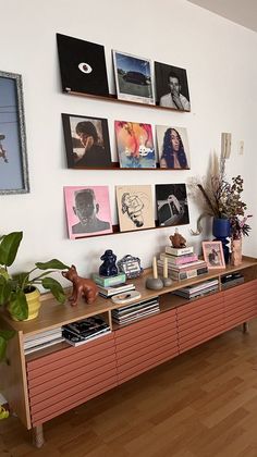 a living room filled with furniture and pictures on the wall above it's bookshelf