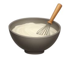 a bowl filled with cream and a whisk on top of it's side