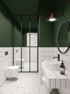 a bathroom with green walls and white tiles