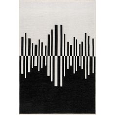 a black and white rug with vertical lines on it, in the shape of a cityscape