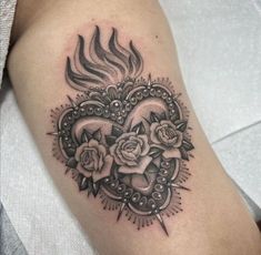 a black and white tattoo with roses in the shape of a heart