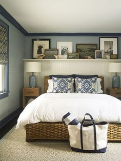 a bedroom with blue walls, white bedding and wicker baskets on the floor