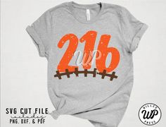 a gray shirt with the number twenty six on it and an orange train track in the middle