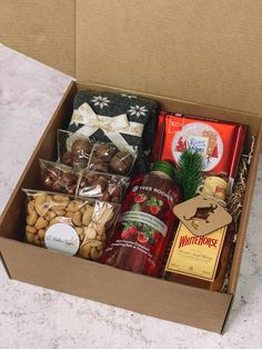 a box filled with assorted snacks and condiments on top of a table