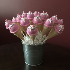 pink cupcakes in ice cream cones with sprinkles