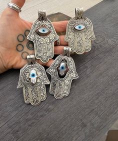 Big hamsa pendants made with alloy metal. They are big statement pieces, that are super light and comfortable to wear. Available now, chppse your favorite from te 7 different Hamsa pendants that you can choose from. Each comes with a cord that you can wear right away. A most have addition to your jewelry collection. Pendant 1- 3.25 inch- 8.1cm long (includes bail on the top), 2.10 inch- 5.4cm wide. Pendant 2- 3.10 inch- 7.8cm long (includes bail on the top) 2 inch- 5cm wide Pendant 3- 3 inch- 7. Bohemian Evil Eye Metal Jewelry, Silver Jewelry With Large Pendant For Good Luck, Silver Bohemian Jewelry For Good Luck, Jewish Necklace, Necklace Evil Eye, Hand Pendant, Hamsa Pendant, Hamsa Necklace, Eye Pendant