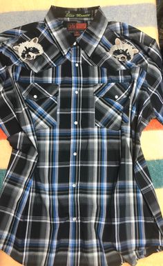 "Raccoons! About this shirt: 2XL. Black plaid snap shirt Collar:18\" Armpit to Armpit flat:28\" Sleeve: 25\" Original brand: canyon guide outfitters About the 'embroidered vintage' shirts: We collect basic vintage/second hand western shirts (many are impossible to date, we shop by style more than by age for these. We draw things, do some editing and programming, and then sew these things onto the old shirts in our East Nashville shop. End result is this- an old shirt reinvented. Basic made inter Country Style Shirt For Summer Rodeo, Black Short Sleeve Western Tops, Western Style Cotton Shirt With Short Sleeves, Western Style Short Sleeve Shirt For Rodeo, Casual Short Sleeve Shirt For Ranch, Embroidered Western Shirt, East Nashville, Single Shirt, Old Shirts