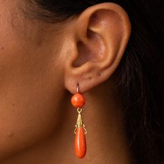 The Story These are a gorgeous pair of antique dangle earrings with lovely color and movement. Made during the Victorian era in France, each earring has two coral cabochons, a round piece at the top, and an elongated teardrop shape piece at the bottom. The bottom pieces are independently attached, giving them movement and swing with the wearer. The gold is warm and buttery and has detailed Etruscan Revival elements. Complete with French hallmarks, they hang 1.83 inches long and look incredible o Orange Pierced Earrings For Formal Occasions, Formal Orange Pierced Earrings, Victorian Cabochon Drop Earrings, Orange Dangle Earrings For Formal Occasions, Elegant Orange Drop Earrings, Orange Formal Earrings, Elegant Orange Pierced Earrings, Stood Earrings, French Victorian