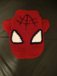 a crocheted spiderman hat with eyes