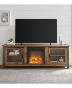 an entertainment center with a fireplace and flat screen tv