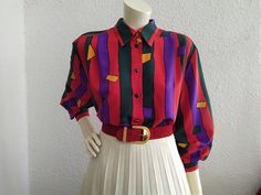 80s red blouse, striped color block top, spring blouse, large sleeve, pop-art blouse, long sleeve, 40 size, colorful holiday shirt, boho summer top.  vintage items always show signs of being worn  please check the measurements before ordering  Measurements laying flat : shoulders :43 cm (17inches)  armpit to armpit :59 cm (23 inches)  total lenght :68 cm (26,5 inches)  sleeve lenght :52 cm (20,5 inches) Bold Red Tops For Spring, Retro Color Block Long Sleeve Tops, Red Retro Long Sleeve Top, Retro Long Sleeve Color Block Tops, Retro Red Long Sleeve Top, Long Sleeve Color Block Blouse For Summer, Summer Color Block Long Sleeve Blouse, Red Patchwork Blouse For Spring, Retro Long Sleeve Patchwork Shirt