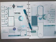 an open planner book with blue and white paper on the pages, including a pen