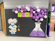 a science themed classroom door decorated with purple and white balloons