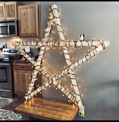 a wooden star decorated with lights in a kitchen