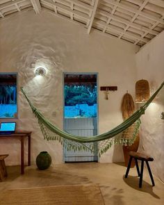 a hammock hanging from the ceiling in a living room