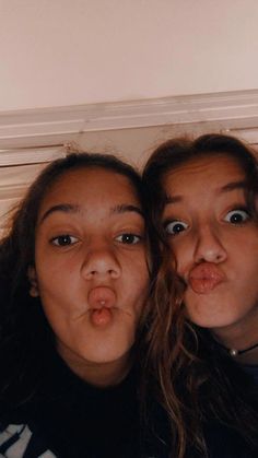 two young women making funny faces with their mouths open and tongue hanging out to the side