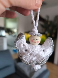 a white angel ornament hanging from a string