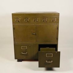 an old metal filing cabinet with two file drawers next to each other on a white background