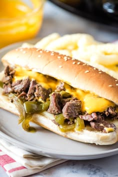 a close up of a sandwich on a plate with french fries