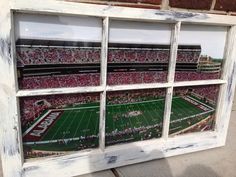 an old window frame with a football game in it