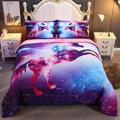 a bed with purple and blue space themed sheets