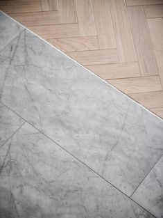 a white marble floor with herringbone pattern