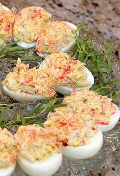 an assortment of deviled eggs on a glass platter