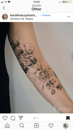 a woman's arm with black and white flowers on it