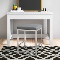 a white desk with a gray stool in front of it