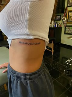 a woman with a tattoo on her stomach saying, keep place for me in the middle