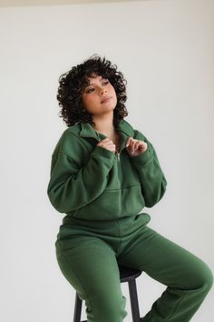 Forest green quarter zip up and matching joggers. This pullover features a gold zipper and relaxed, cropped fit. The joggers are slim fitting with a straight leg. Half-zip Sweatshirt With Zipper For Loungewear, Half-zip Sweatshirt With Zipper Closure For Loungewear, Half-zip Loungewear Hoodie, Zipper Closure Long Sleeve Sweatshirt For Loungewear, Long Sleeve Sweatshirt With Zipper For Loungewear, Athleisure Half-zip Sweater For Loungewear, Cotton Loungewear Top With Zipper Closure, Cotton Tops With Zipper Closure For Loungewear, Zipper Closure Sweatshirt For Fall Loungewear