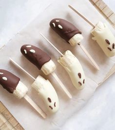 chocolate covered marshmallows are arranged on skewers