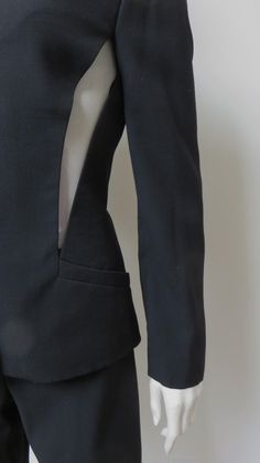 Sleek Fitted Pantsuit With Structured Boning, Fitted Tuxedo Style Structured Pantsuit, Structured Tuxedo Style Fitted Pantsuit, Fitted Tuxedo-style Structured Pantsuit, Structured Fitted Pantsuit For Party, Avant-garde Fitted Formal Blazer, Modern Fitted Long Sleeve Pantsuit, Black Fitted Structured Suit, Modern Fitted Pantsuit With Long Sleeves