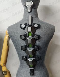 a mannequin with multiple pieces of metal on it's back and sides