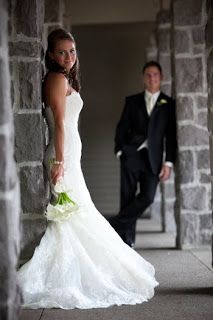 a bride and groom standing in an archway