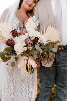 the bride and groom are holding their bouquets