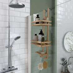 a bathroom with green walls and shelving next to the bathtub is shown in this image