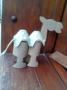 two pieces of cardboard sitting on top of a wooden table next to an open door