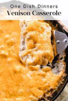 a spoon full of cheesy casserole being lifted from a skillet