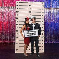 a man and woman standing next to each other holding a sign