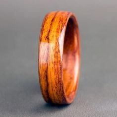 the wooden ring is made out of wood and has an unusual pattern on it's surface