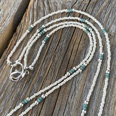 Tiny Dainty Double Strand Beaded Necklace with White and Turquoise Czech Glass Beads. Super Lightweight! Beads: * White Czech Glass - 1mm * Turquoise Seed Beads - 2mm * Silver Spacer Beads - 2mm Clasp: *Silver Plated Lobster Claw Clasp * The model in the pictures is wearing 16 & 18 inches. Choose your Lengths at Checkout! If you don't see a certain length in the drop down menu, please message me with the lengths you would like :) To view more of my original jewelry designs, visit: https://ww White Southwestern Jewelry With Tiny Beads, Silver Multi-strand Necklace For The Beach, Southwestern White Jewelry With Tiny Beads, Bohemian Silver Turquoise Necklace For Beach, Southwestern Style Silver Jewelry For The Beach, Turquoise Multi-strand Jewelry With Tiny Beads, Silver Beaded Necklace With Tiny Beads For The Beach, Bohemian Silver Turquoise Necklace With Spacer Beads, Silver Beaded Necklace For Beach