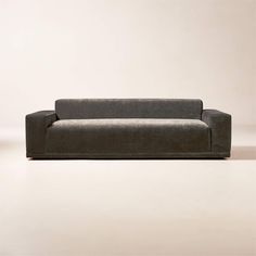 a gray couch sitting on top of a white floor