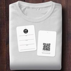 a white t - shirt with a qr code on the front and an id tag on the back